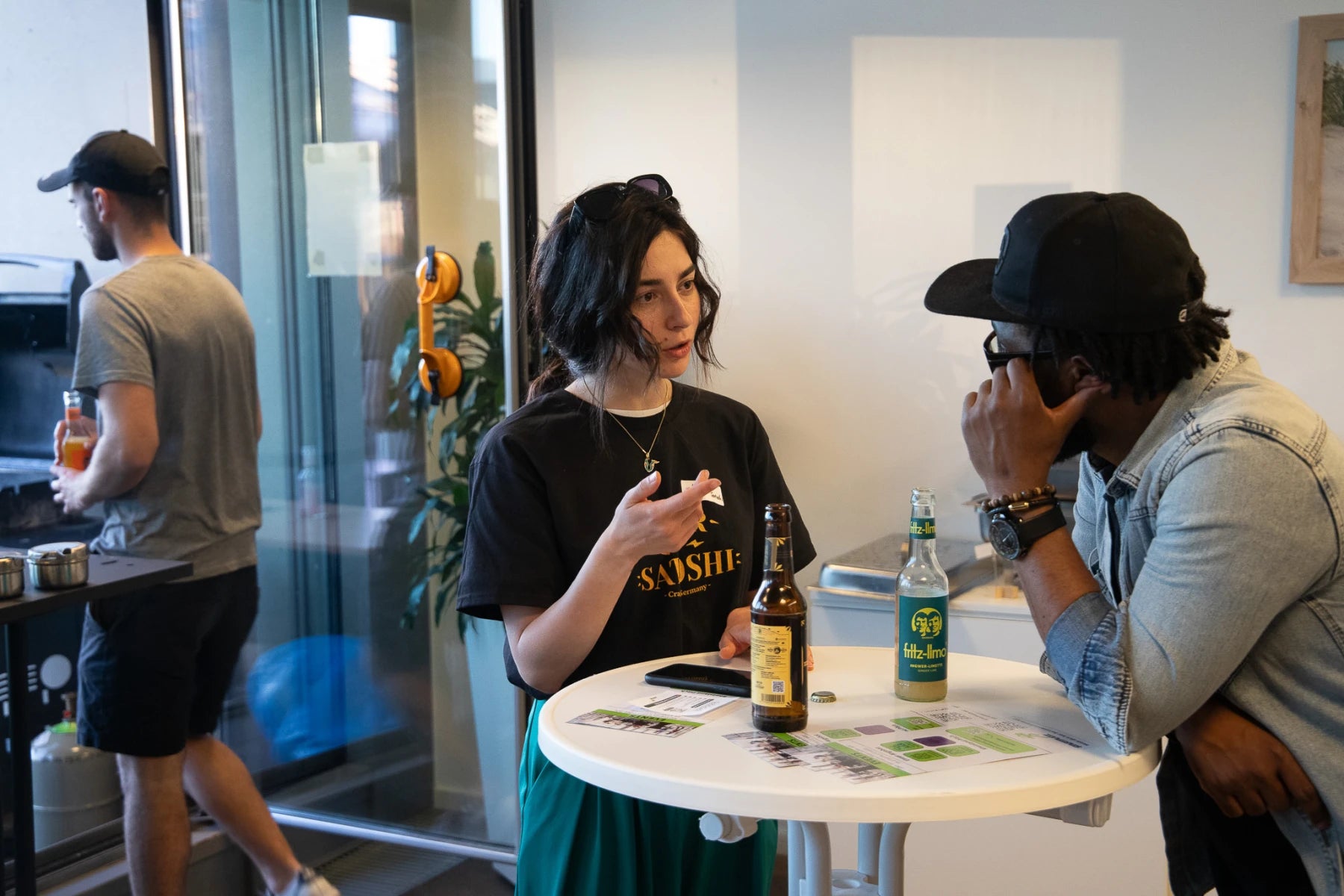 A Beer of Satoshi team member speaking directly with a visitor
