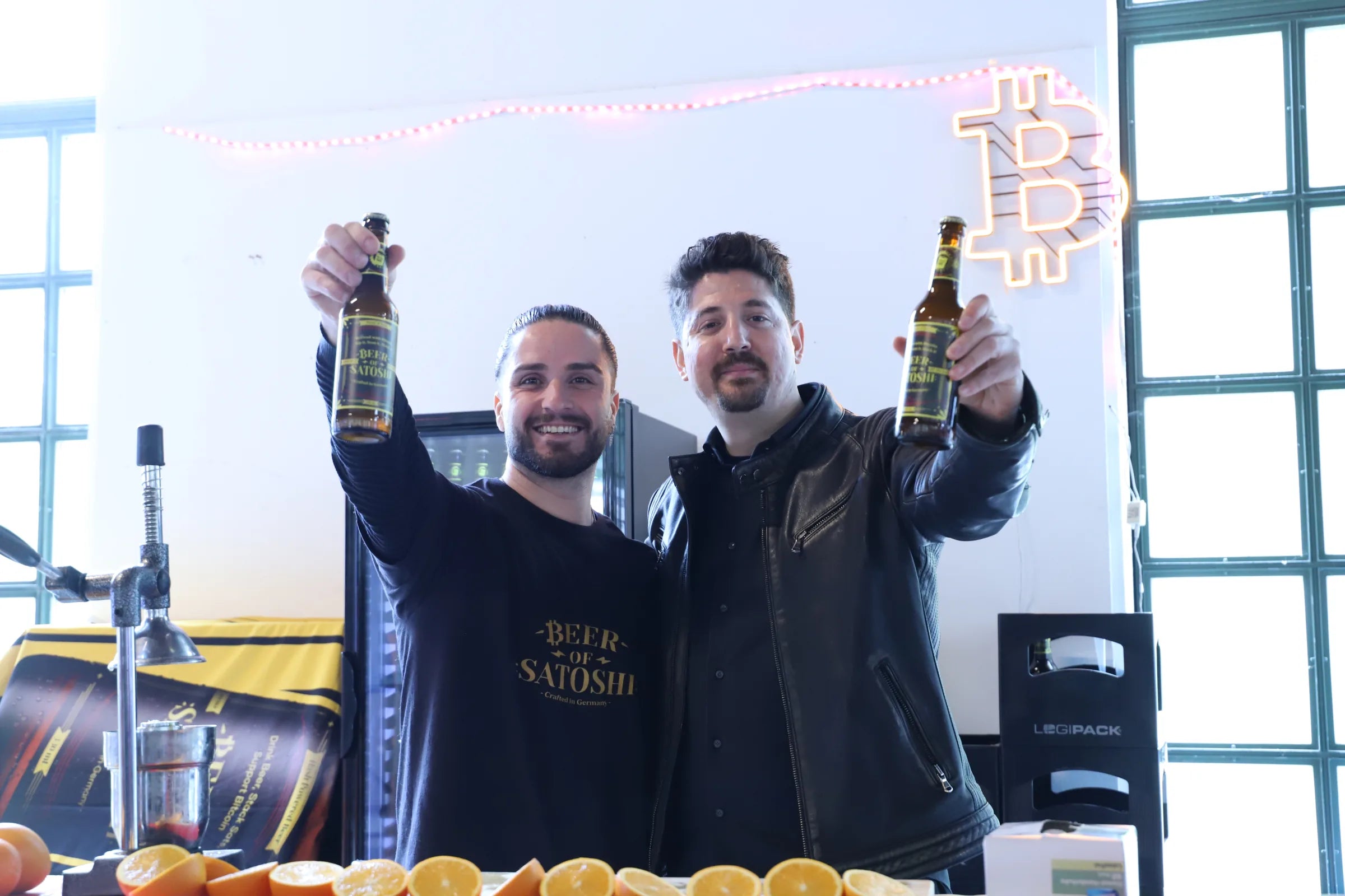 Beer of Satoshi team members raising Genesis Lager bottles at Bitcoin Forum Ingolstadt