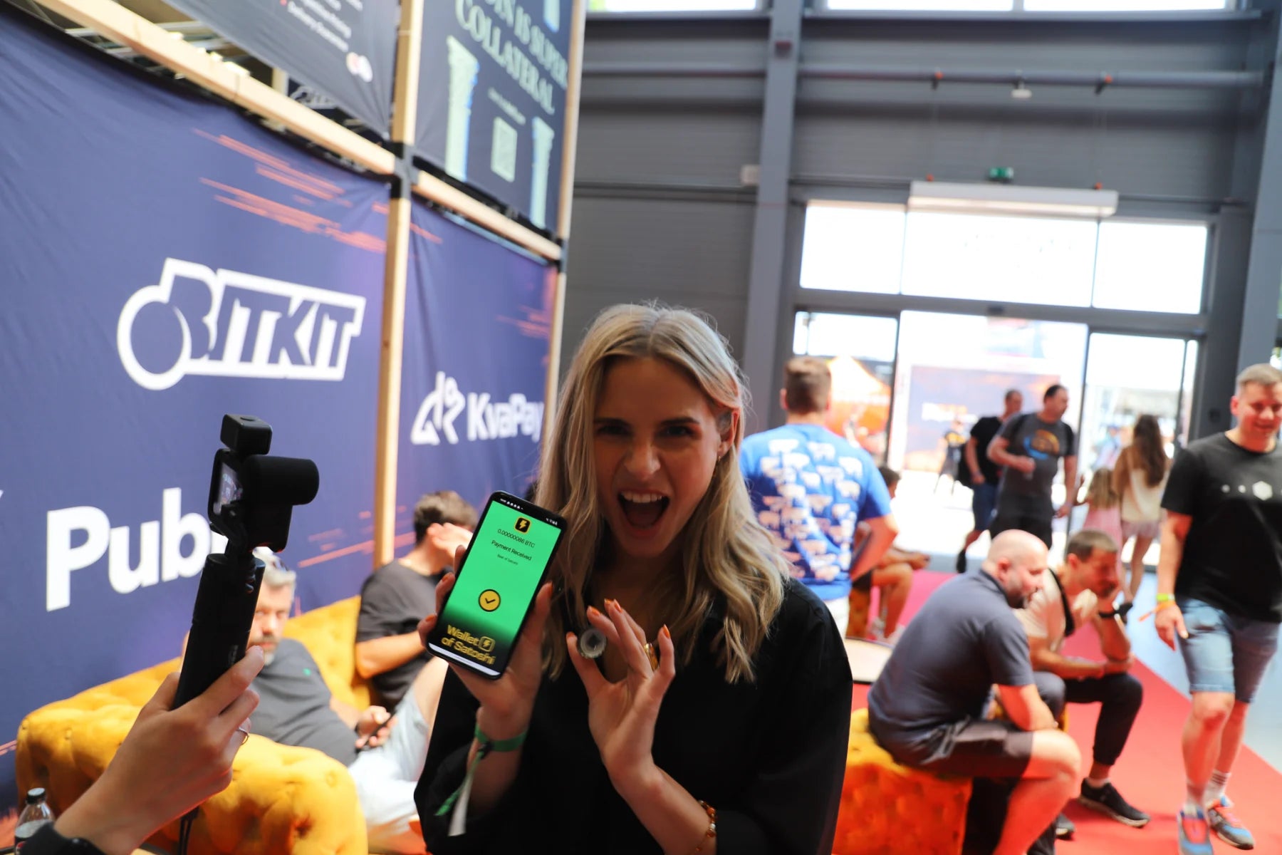 A BTC Prague visitor showing her claimed Beer of Satoshi Bitcoin reward