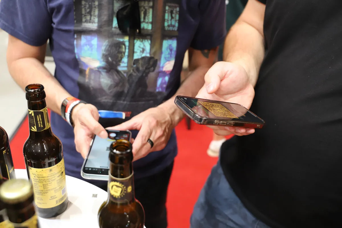 A Beer of Satoshi bottle cap being scanned with a phone