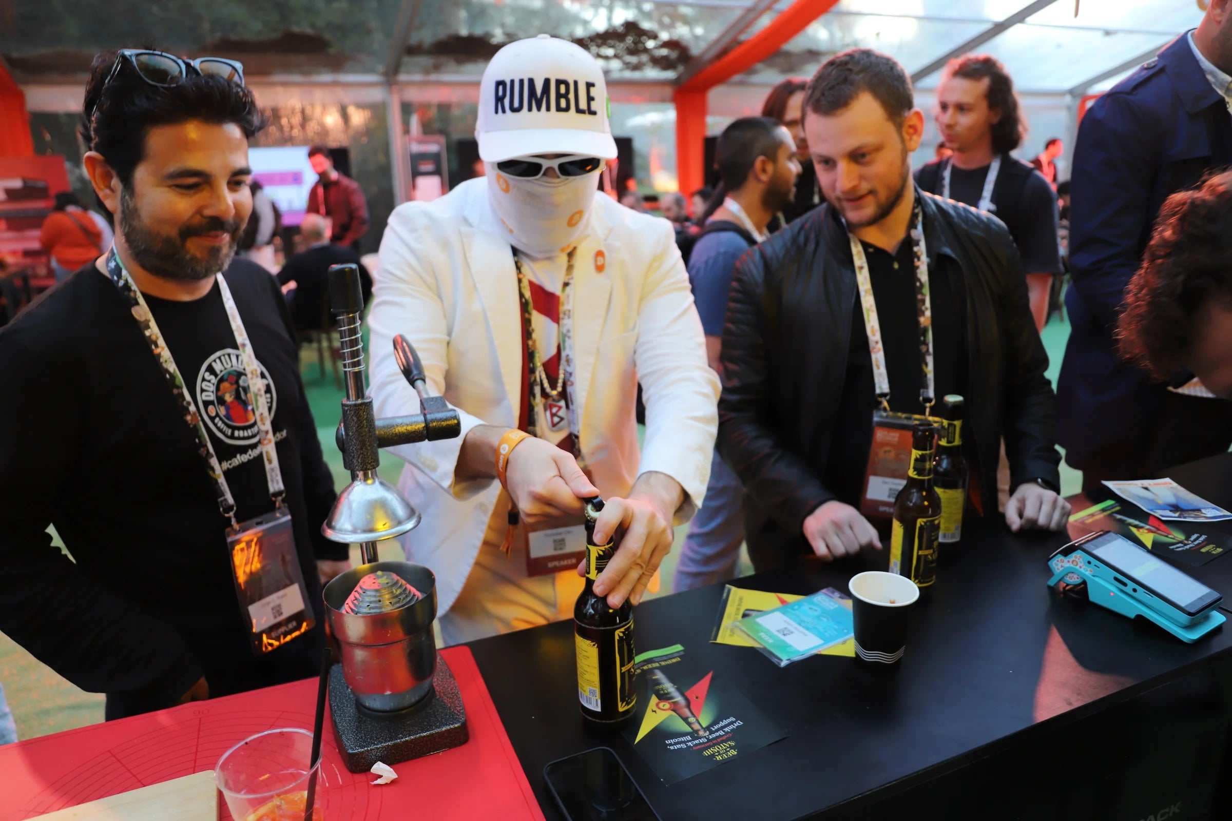 Besucher entdecken Beer of Satoshi gemeinsam am Tisch beim Plan ₿ Forum Lugano